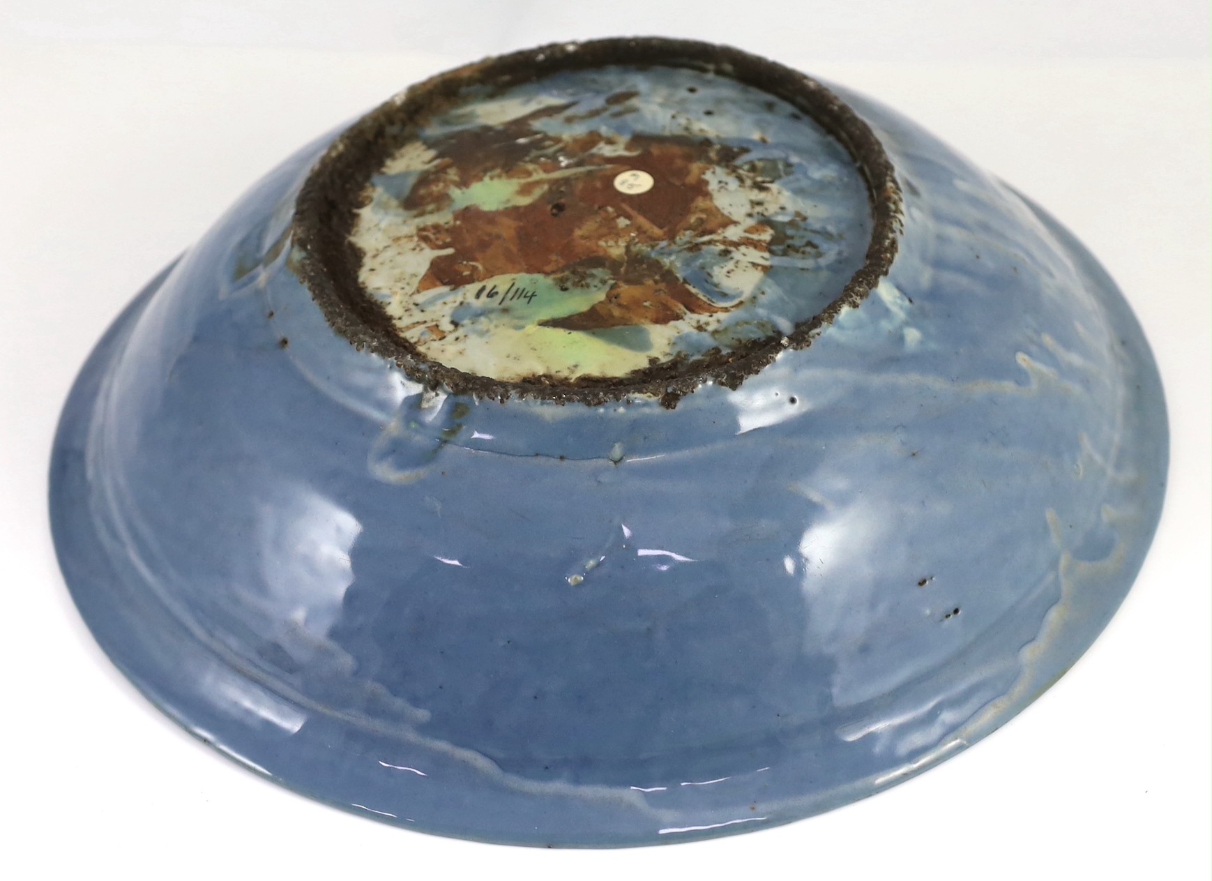 A Chinese Swatow slip-decorated blue glazed deep dish, Zhangzhou kilns, early 17th century, 38cm wide, crack to base